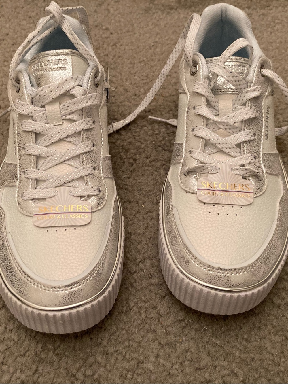 Woman’s 8 1/2 silver/white Sketchers